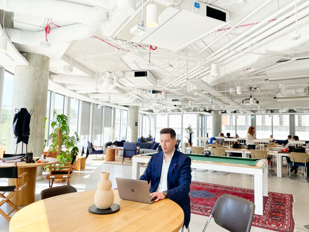 Bogdan Bancila, Warsaw Hub Manager at Digitall sitting in common area
