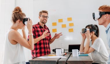 Business people using virtual reality goggles during meeting